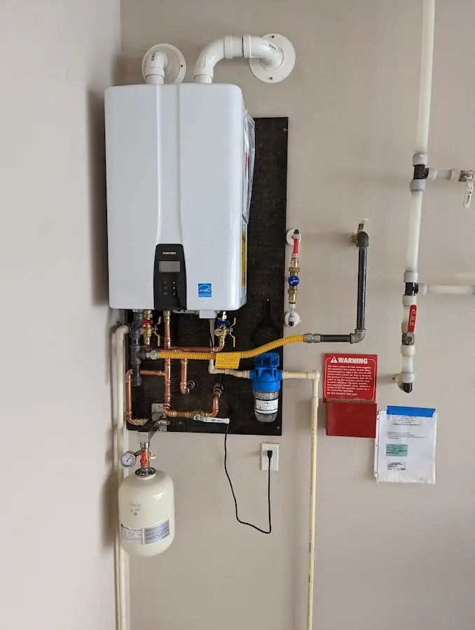 Professional plumber installing copper piping in a Carl Junction home